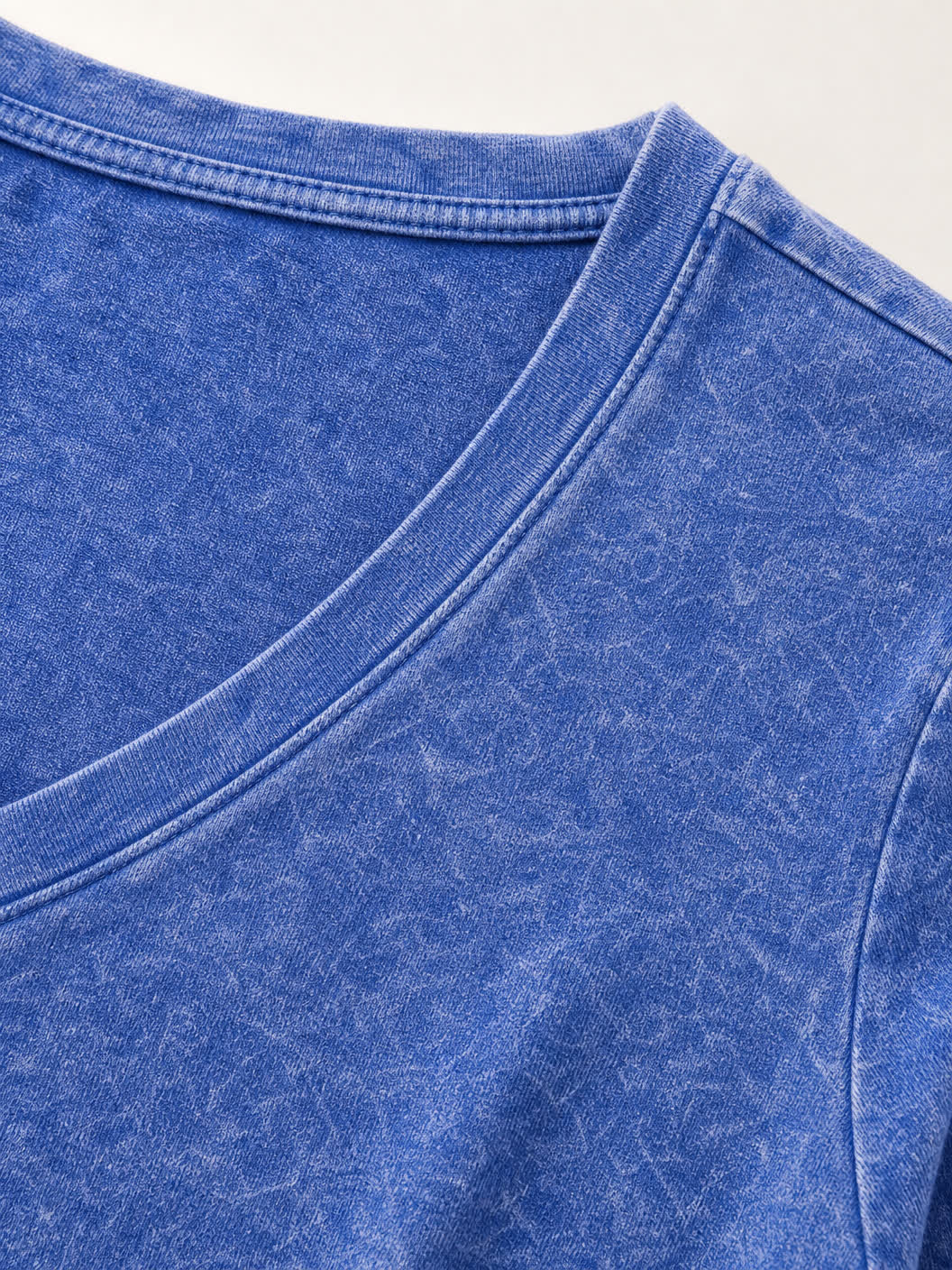 Close-up of a blue washed 100% cotton V-neck top by LoomBasics.