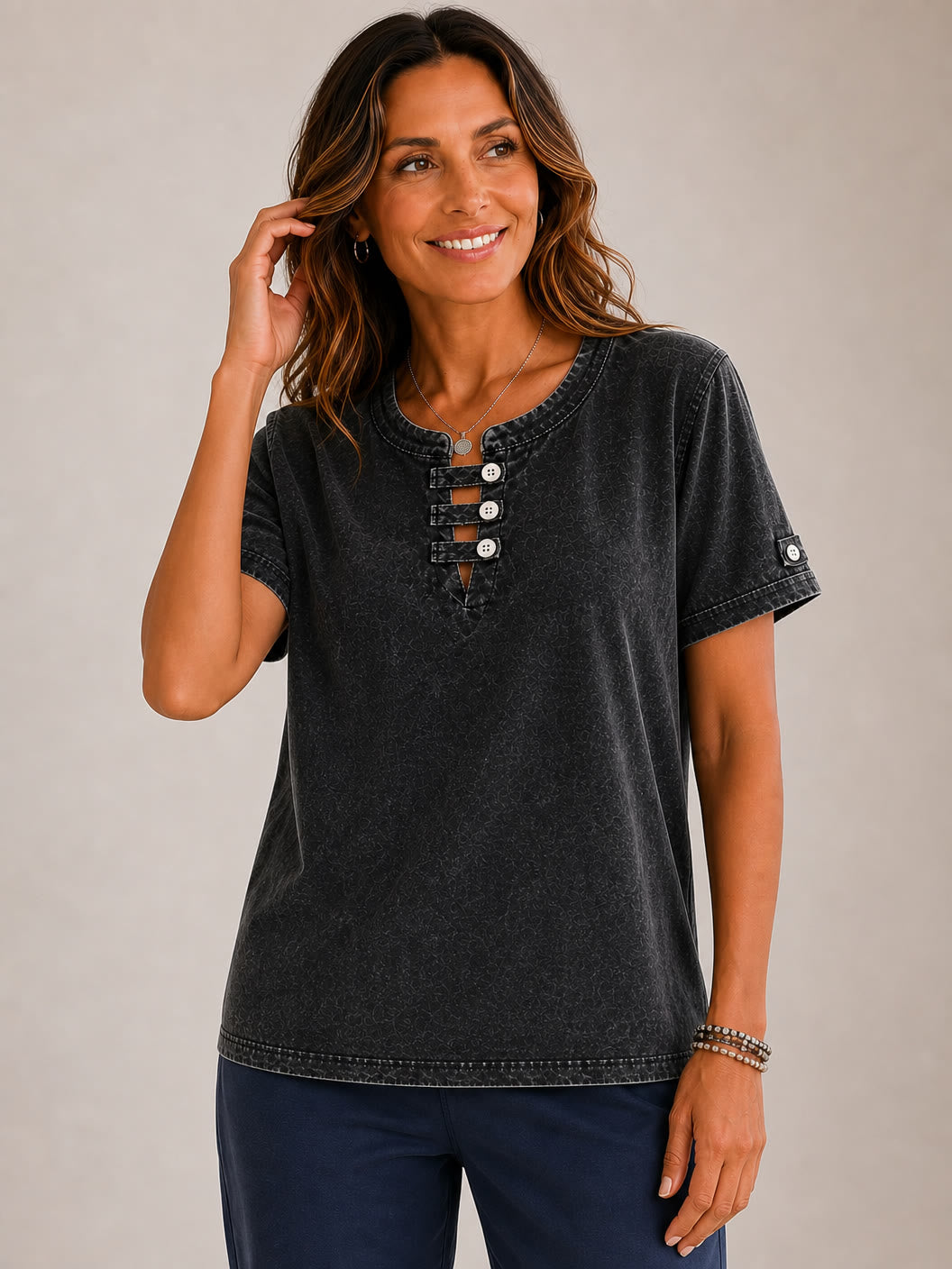 Woman wearing a LoomBasics charcoal grey 100% cotton short sleeve tee with a buttoned neckline.
