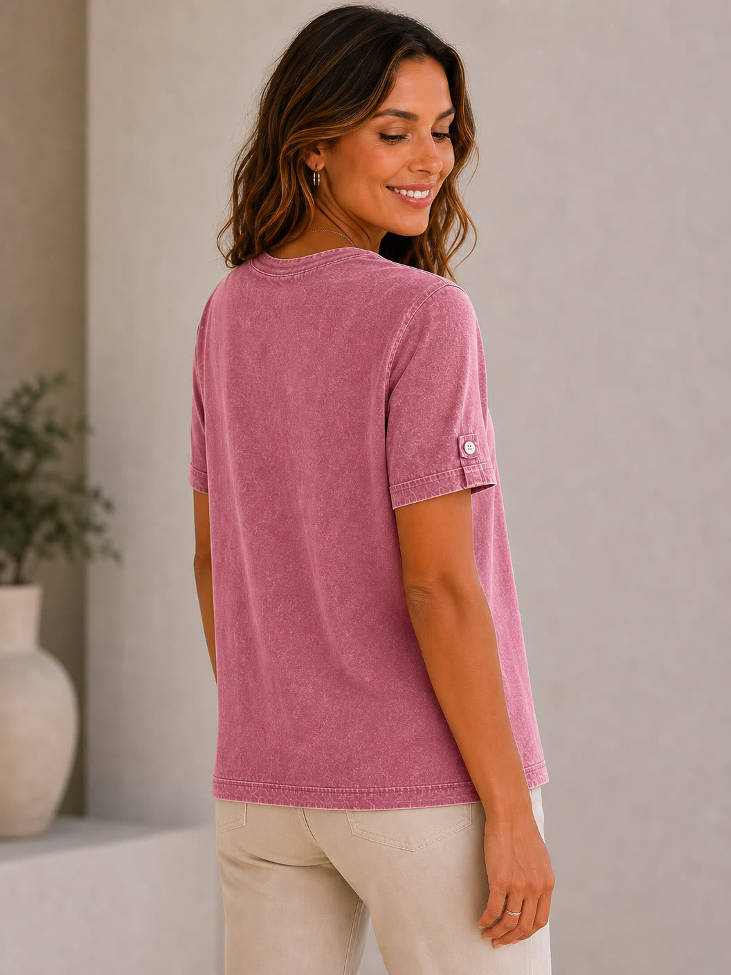 Woman wearing a LoomBasics mauve mineral wash 100% cotton short sleeve tee and beige pants.