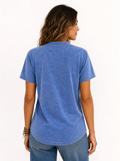Back view of a woman wearing a LoomBasics blue 100% cotton short sleeve tee and blue jeans.