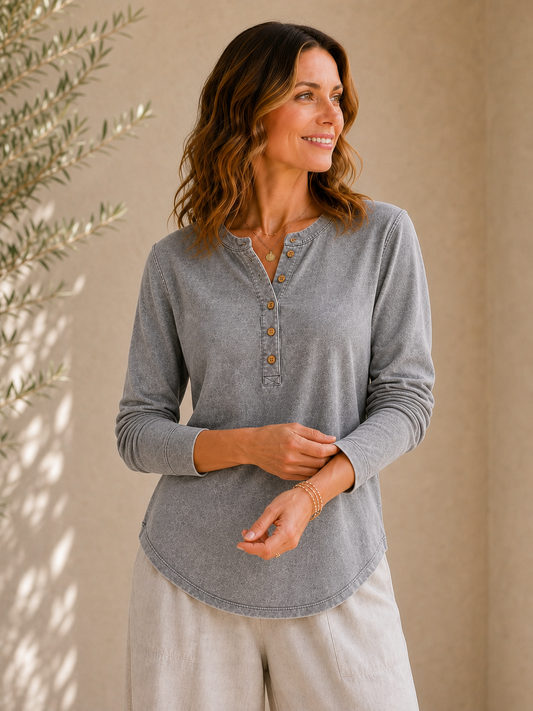 Woman wearing a LoomBasics vintage grey 100% cotton long sleeve shirt and beige pants.