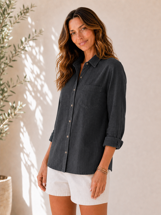 Woman wearing a LoomBasics 100% cotton charcoal grey button-up shirt with white shorts.