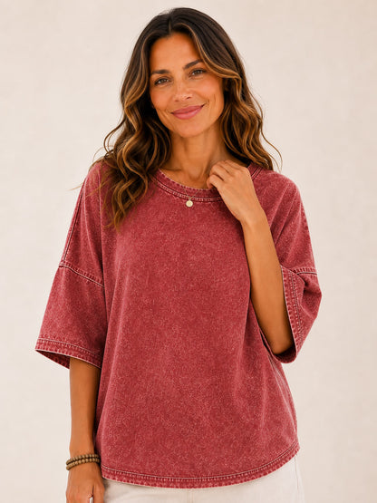 Woman wearing a LoomBasics washed red 100% cotton blouse with oversized sleeves