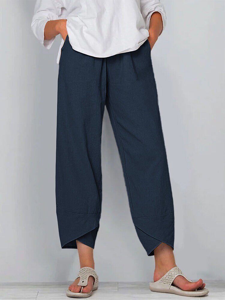 Woman wearing LoomBasics navy blue 100% cotton capri pants and beige sandals.