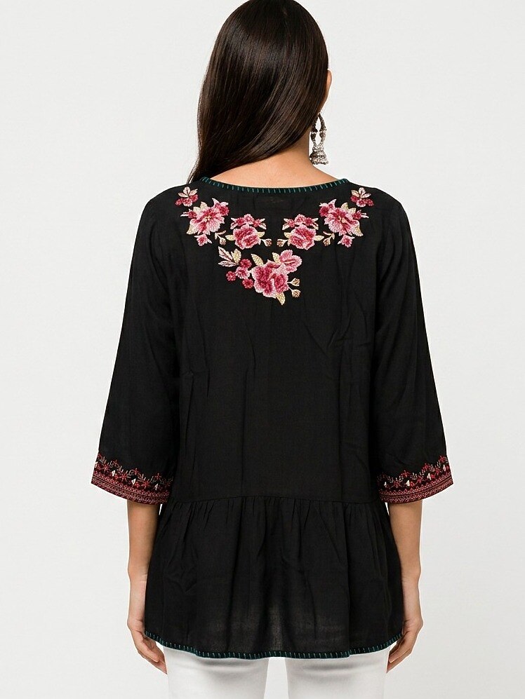 Back view of a LoomBasics black cotton tunic shirt with pink floral embroidery