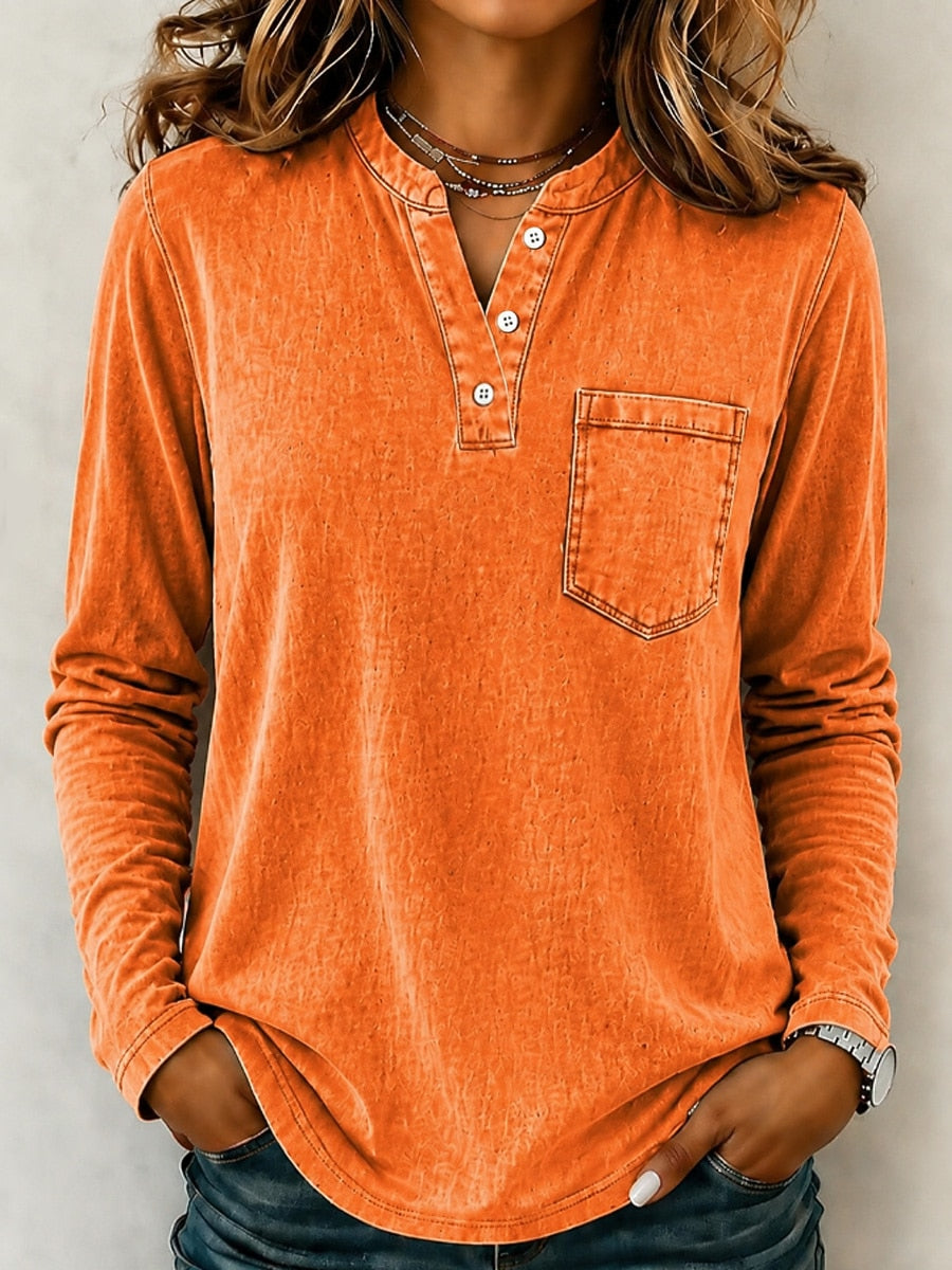Woman wearing a LoomBasics vintage orange 100% cotton long sleeve henley shirt with a chest pocket.