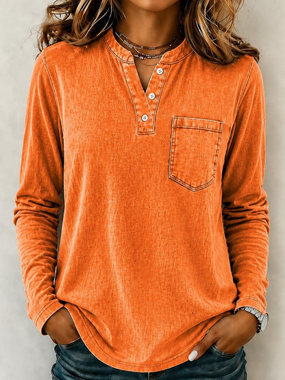 Woman wearing a LoomBasics vintage orange 100% cotton long sleeve henley shirt with a chest pocket.