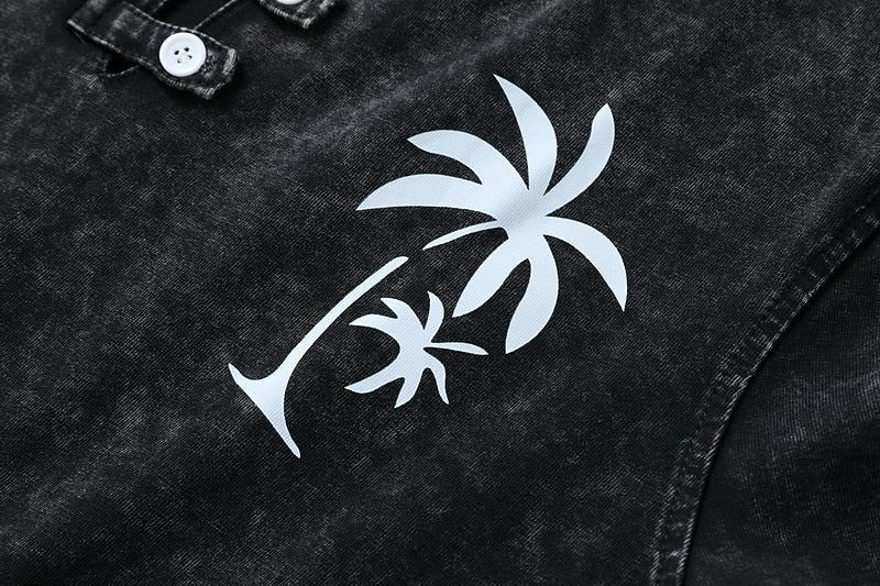 Close-up of a dark grey cotton Henley shirt by LoomBasics featuring a white palm tree graphic.
