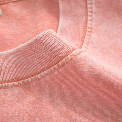 Close-up of the neckline stitching on a coral pink LoomBasics women's 100% cotton V-neck tee.