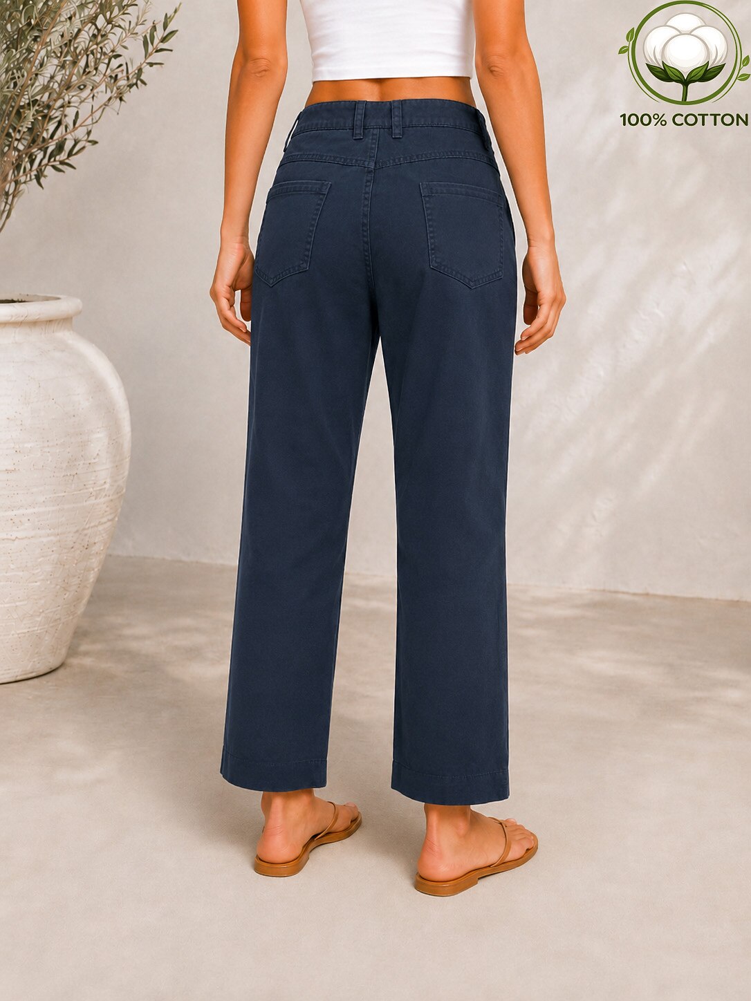 Back view of a woman wearing LoomBasics navy blue 100% cotton pocket denim jeans.