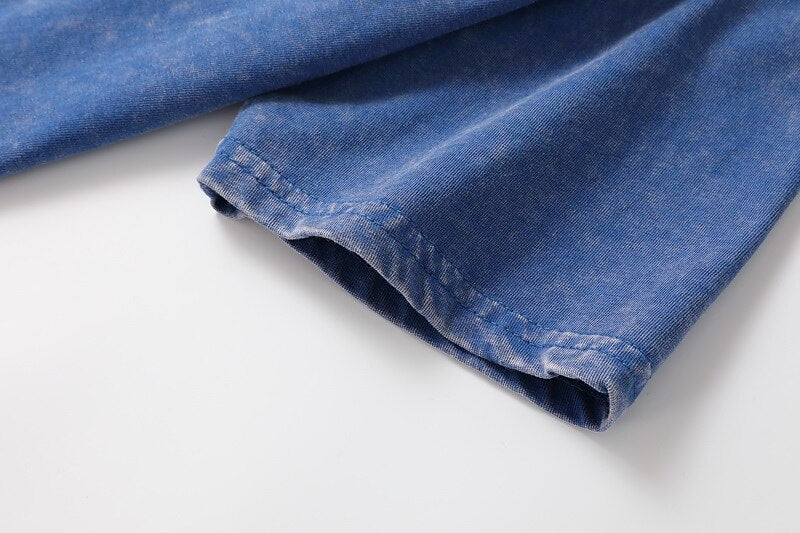 Close-up of the stitched sleeve hem of a blue washed cotton LoomBasics Henley tee.
