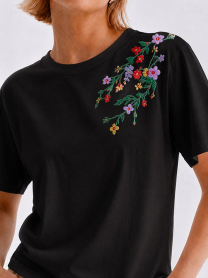 LoomBasics black 100% cotton t-shirt featuring colorful floral embroidery on the shoulder
