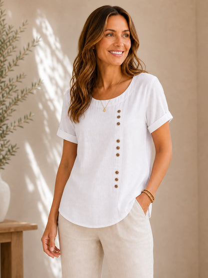 Woman wearing a LoomBasics soft button 100% cotton white blouse and beige trousers.