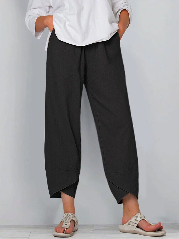 Woman wearing LoomBasics black 100% cotton capri pants with a white shirt and beige sandals